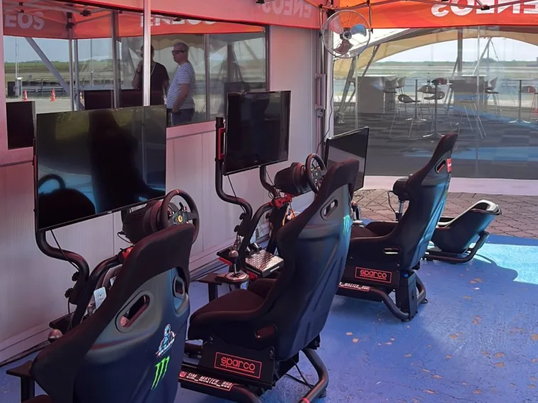 Sim Master simulators under the ENEOS tent at a racetrack