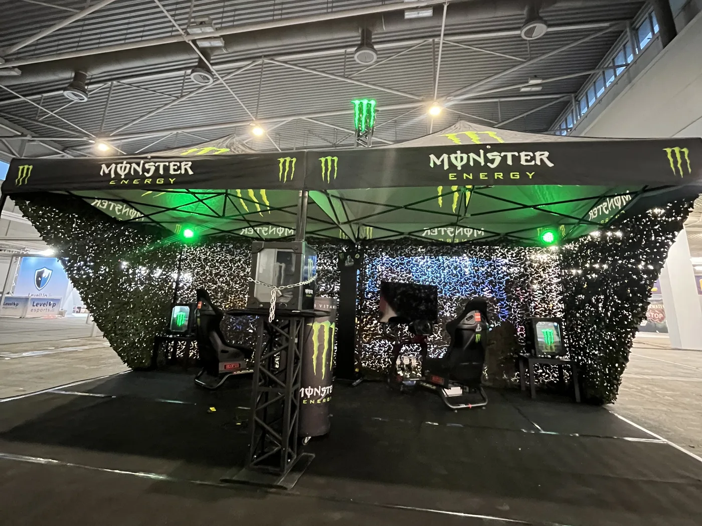 Monster Energy stand with two Sim Master simulators at a trade fair