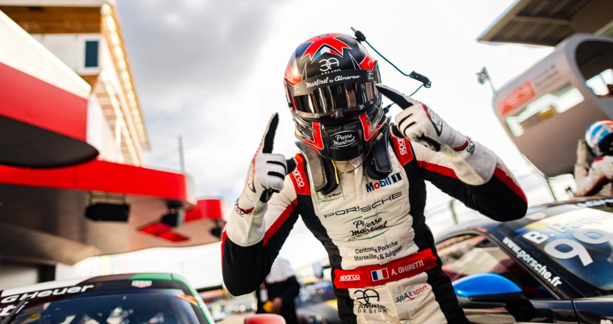 A driver celebrating a win in the pit lane